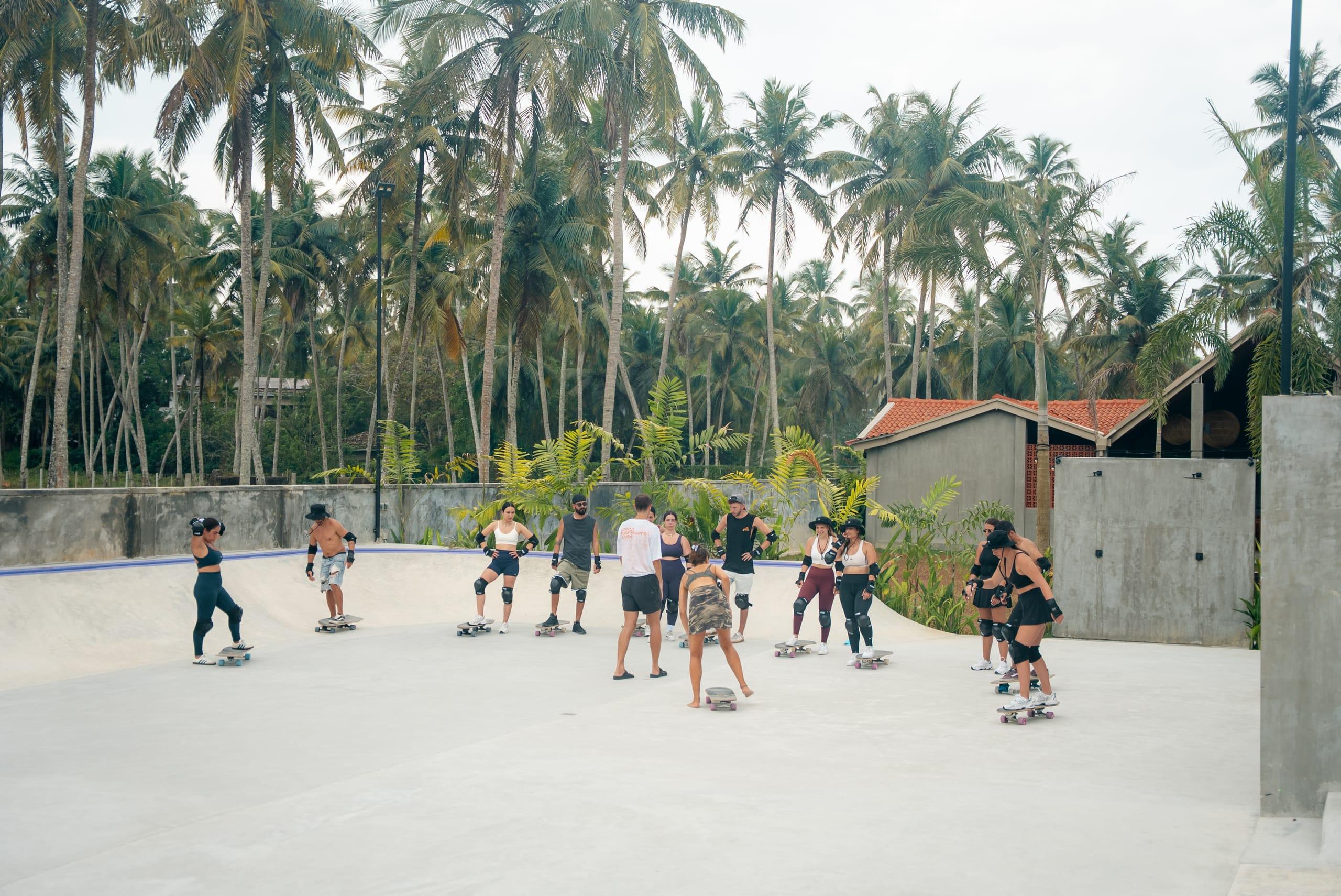The whole group learning the skate bowl together, palms overhead