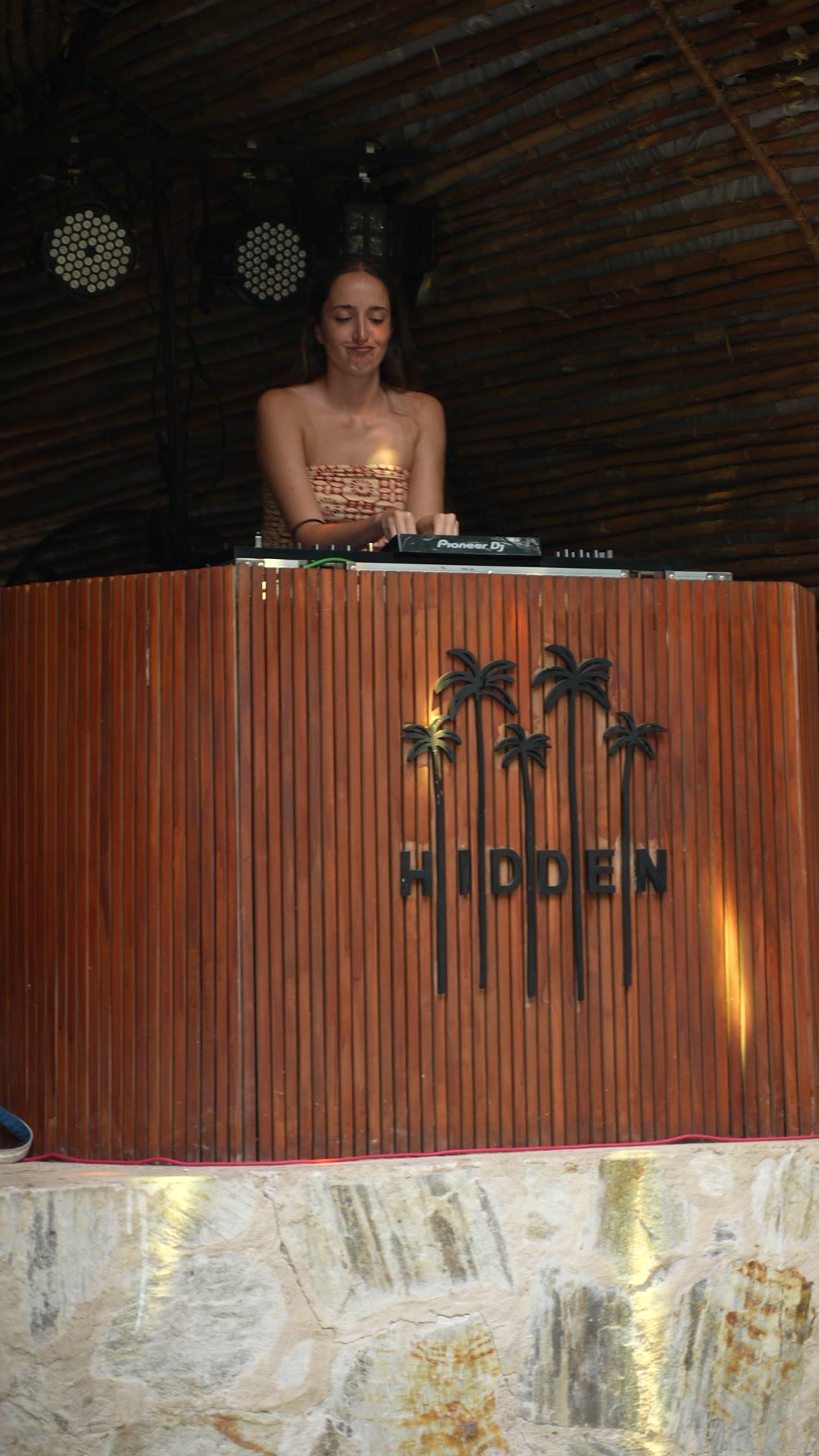 The DJ at the Hidden booth, under the bamboo ceiling
